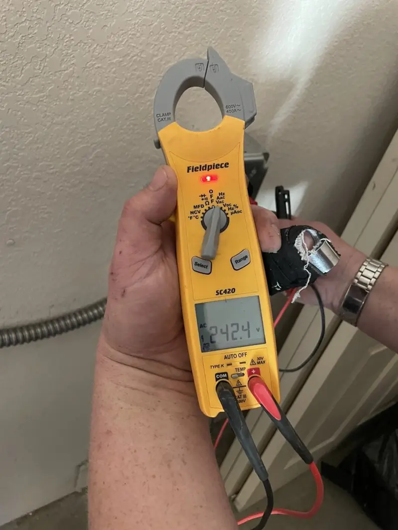 Voltage testing with clamp meter during Circuit Breaker Repair in Linton Hall